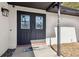 Home's front door featuring glass panels, black hardware and neutral mat at 6121 Bass Hwy, St Cloud, FL 34771