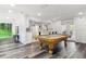The game room features an ornate billiard table with a nearby kitchen and french door access to the exterior at 6121 Bass Hwy, St Cloud, FL 34771