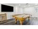 Well-lit game room includes a billiard table, mounted TV, and convenient bar area for entertaining at 6121 Bass Hwy, St Cloud, FL 34771