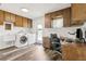 Multipurpose laundry room with washer, dryer, desk, and cabinets, a functional workspace at 6121 Bass Hwy, St Cloud, FL 34771