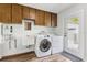 Laundry room with washer, dryer, sink, and ample cabinet space, convenient for household chores at 6121 Bass Hwy, St Cloud, FL 34771