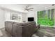 Inviting living room featuring a large window, ceiling fan and wooded mural at 6121 Bass Hwy, St Cloud, FL 34771