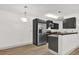 Well-lit kitchen featuring stainless steel appliances, granite countertops, and updated cabinets at 629 Dory Ln # 108, Altamonte Springs, FL 32714