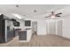 Open-concept living room and kitchen with stainless steel appliances and hardwood floors at 629 Dory Ln # 108, Altamonte Springs, FL 32714