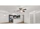 Well-lit living room featuring stainless steel appliances, light hard wood floors, and gray cabinets at 629 Dory Ln # 108, Altamonte Springs, FL 32714