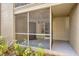 View of the home's screened porch, front door, and landscaping provides secure outdoor space at 629 Dory Ln # 108, Altamonte Springs, FL 32714