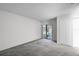 Bright bedroom with carpet flooring and sliding glass door leading to a screened patio at 7416 Windsome Ct, Orlando, FL 32810