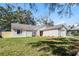 Single story home with a large backyard, attached garage, and newly landscaped front yard at 7416 Windsome Ct, Orlando, FL 32810