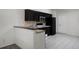 Efficient kitchen featuring dark wood cabinets, a breakfast bar, and tile flooring at 7416 Windsome Ct, Orlando, FL 32810