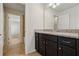 Dark wood vanity with granite countertop and mirror at 8833 Corcovado Dr, Kissimmee, FL 34747