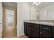 Bathroom featuring granite countertops, dark wood cabinets, and tiled flooring at 8833 Corcovado Dr, Kissimmee, FL 34747