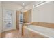 Bathroom with garden tub, walk-in shower, and backyard access at 8833 Corcovado Dr, Kissimmee, FL 34747