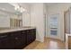 Double-sink bathroom with granite countertops and access to the backyard at 8833 Corcovado Dr, Kissimmee, FL 34747