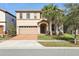 Two-story house with a two-car garage and manicured lawn at 8833 Corcovado Dr, Kissimmee, FL 34747