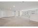 Spacious living room with plush carpeting, recessed lighting, and multiple windows at 8833 Corcovado Dr, Kissimmee, FL 34747