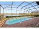 Screened-in pool and spa overlooking a lake at 8833 Corcovado Dr, Kissimmee, FL 34747