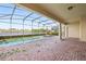 Spacious screened-in patio with a private pool and spa overlooking a serene lake view at 8833 Corcovado Dr, Kissimmee, FL 34747