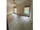 Spacious bedroom with light wood-look floors and ceiling fan at 89 Crooked Pine Rd, Port Orange, FL 32128