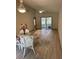 Dining room with light wood-look floors and wicker chairs at 89 Crooked Pine Rd, Port Orange, FL 32128