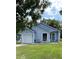 Cute light blue house with a white garage door and a nicely landscaped lawn at 89 Crooked Pine Rd, Port Orange, FL 32128
