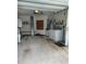 Garage with washer, dryer, and ample storage shelving at 89 Crooked Pine Rd, Port Orange, FL 32128