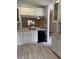 White kitchen with black appliances and light grey tile floors at 89 Crooked Pine Rd, Port Orange, FL 32128