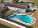 Aerial view showing home's kidney-shaped pool and backyard at 911 Shady Park Ter, Daytona Beach, FL 32117