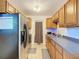 Efficient kitchen with stainless steel appliances and oak cabinets at 911 Shady Park Ter, Daytona Beach, FL 32117