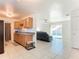 Kitchen with oak cabinets, tile floor, and view of living room at 911 Shady Park Ter, Daytona Beach, FL 32117
