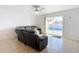 Living room with reclining sofa and sliding door to pool at 911 Shady Park Ter, Daytona Beach, FL 32117