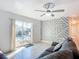 Living room with pool view, geometric wall art, and sliding glass doors at 911 Shady Park Ter, Daytona Beach, FL 32117