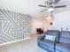 Living room with sectional sofa and geometric accent wall at 911 Shady Park Ter, Daytona Beach, FL 32117