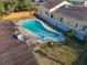 Kidney-shaped pool in backyard with surrounding grass at 911 Shady Park Ter, Daytona Beach, FL 32117