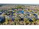 Aerial view of townhouses community by a pond at 9746 Tiramasu Trl, Orlando, FL 32829