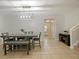 Bright dining room with table, bench, and entryway view at 9746 Tiramasu Trl, Orlando, FL 32829