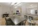 Open concept dining room with gray table and chairs at 9746 Tiramasu Trl, Orlando, FL 32829