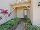 Townhouse entry with green door and brick walkway at 9746 Tiramasu Trl, Orlando, FL 32829