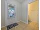 Bright foyer with tile flooring and laundry closet at 9746 Tiramasu Trl, Orlando, FL 32829