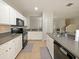 Modern kitchen with black appliances and gray countertops at 9746 Tiramasu Trl, Orlando, FL 32829
