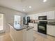 Kitchen with island, stainless steel appliances, and access to backyard at 9746 Tiramasu Trl, Orlando, FL 32829