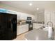 Modern kitchen with stainless steel appliances and white cabinets at 9746 Tiramasu Trl, Orlando, FL 32829