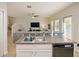 Kitchen island with sink and view into living room at 9746 Tiramasu Trl, Orlando, FL 32829