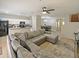 Open concept living room with sectional sofa and kitchen at 9746 Tiramasu Trl, Orlando, FL 32829