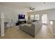 Spacious living room with sectional sofa and TV at 9746 Tiramasu Trl, Orlando, FL 32829