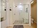 Large walk-in shower with glass enclosure and built-in seat at 9746 Tiramasu Trl, Orlando, FL 32829