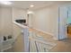 Upstairs hallway with light wood floors and access to bedrooms at 9746 Tiramasu Trl, Orlando, FL 32829