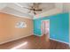 Spacious bedroom with wood-look floors and ceiling fan at 1921 Nicholas Pl, St Cloud, FL 34771
