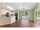 Open-concept dining area with wood flooring and access to the backyard at 1921 Nicholas Pl, St Cloud, FL 34771