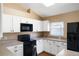 Modern kitchen with white cabinets, black appliances, and laminate countertops at 1921 Nicholas Pl, St Cloud, FL 34771