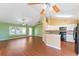 Open kitchen features wood flooring, an island, and modern appliances at 1921 Nicholas Pl, St Cloud, FL 34771